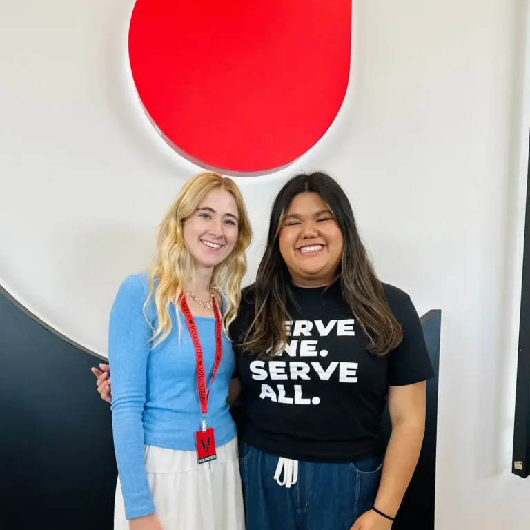 Two young girls volunteering in the church lobby