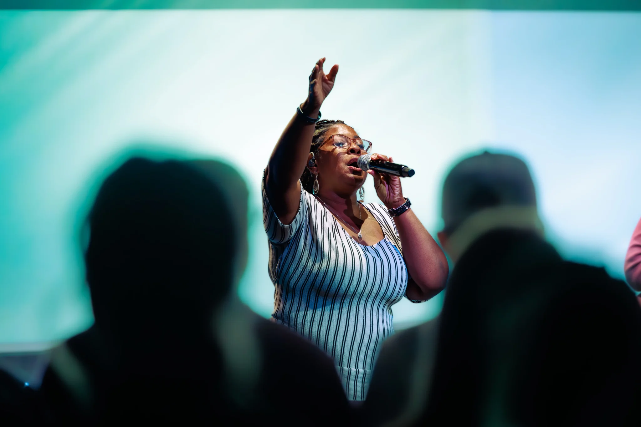 A woman vocalist mid-song during a worship service