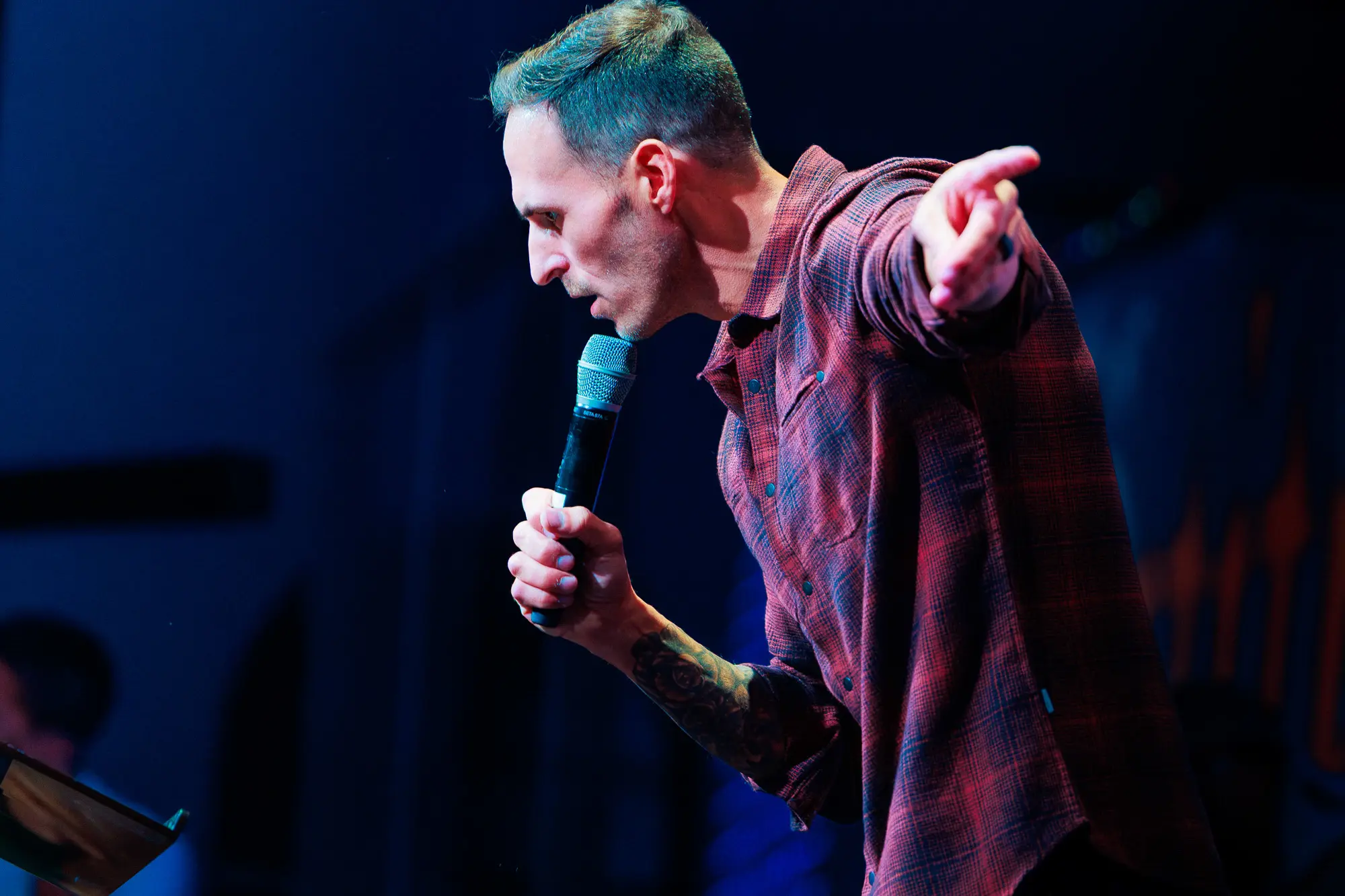 Pastor Jared Fabac speaking into a microphone during a sermon
