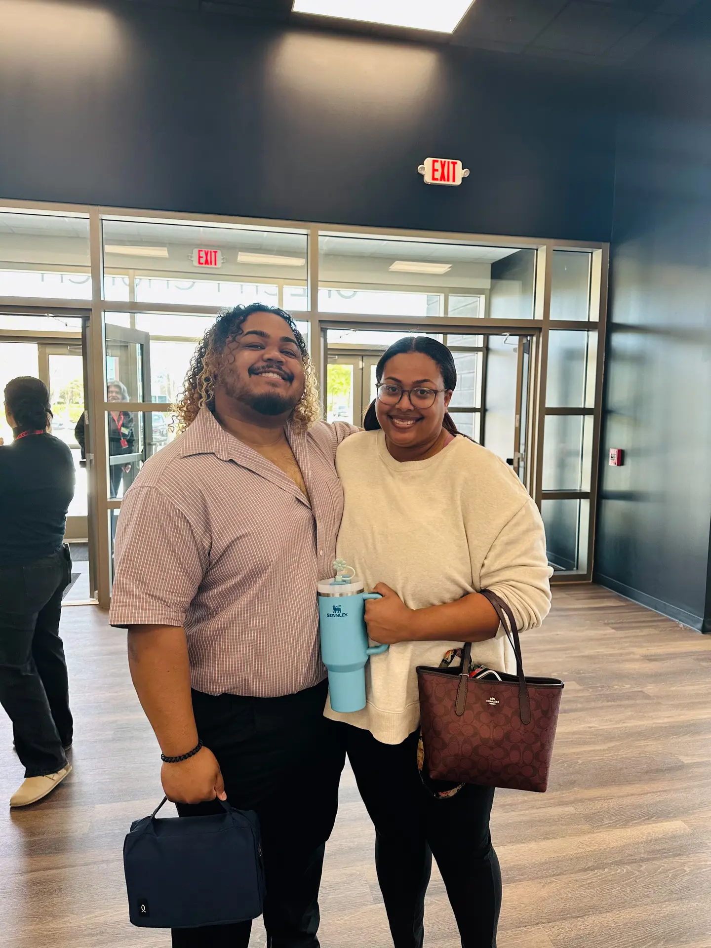 A man and woman standing next to each other in a church lobby