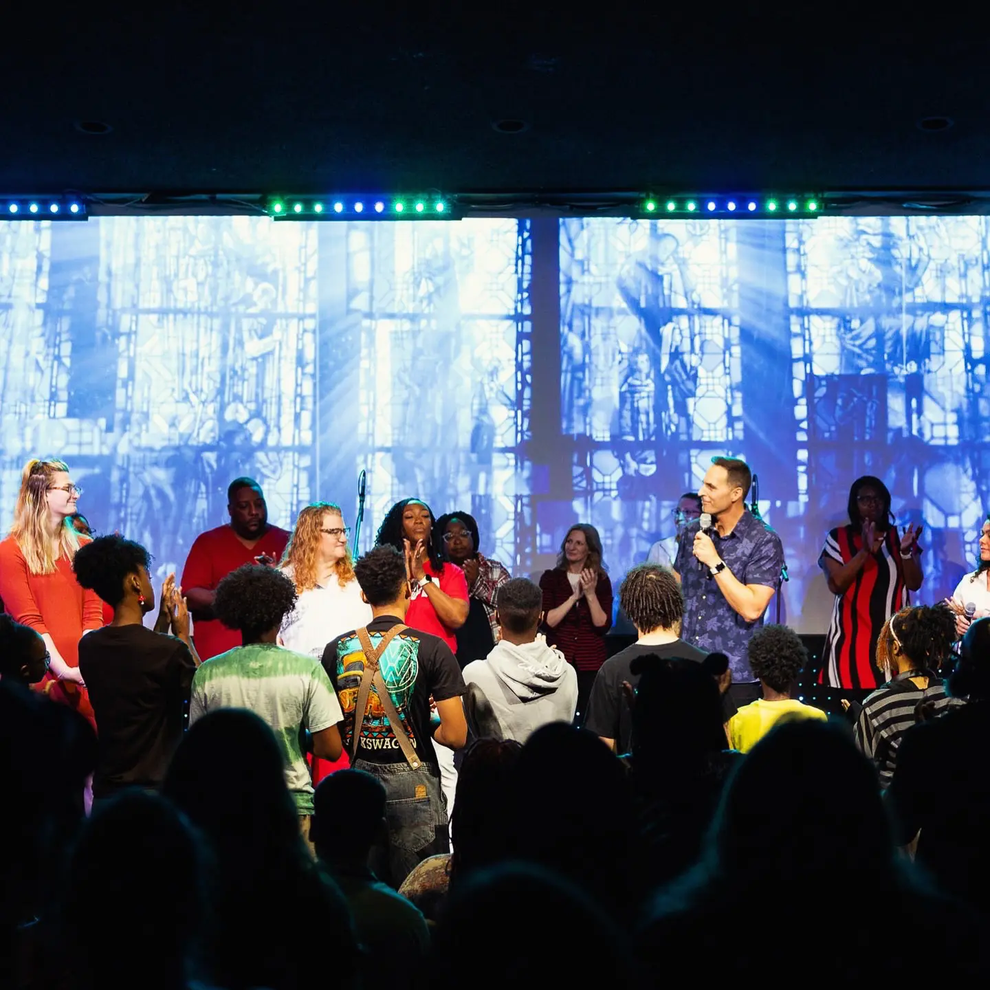 Pastor Jared Fabac speaking on the stage during a worship service