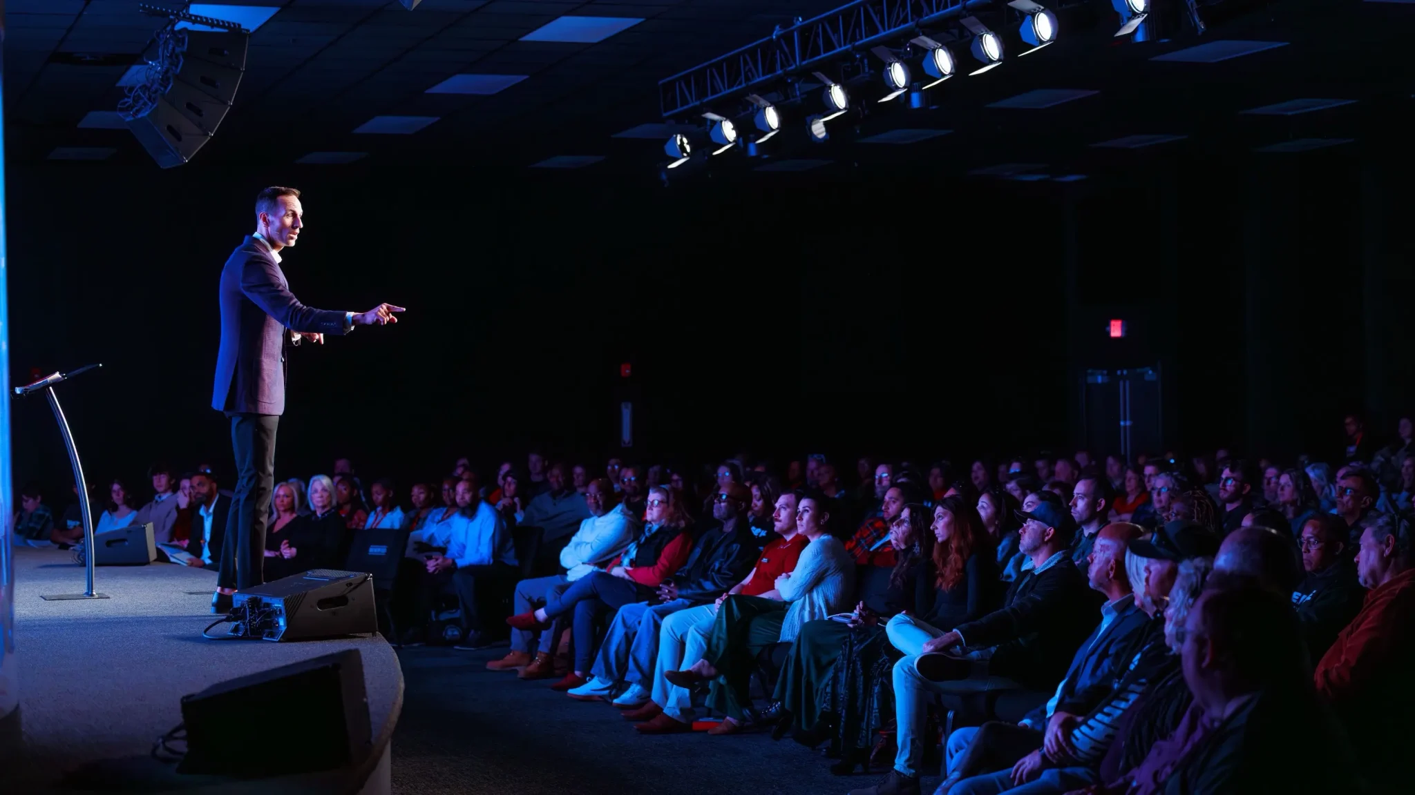 Pastor Jared Fabac giving a sermon in front of the congregation during a worship service